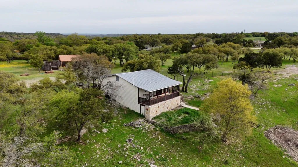 A charming and secluded stone cottage at Love of the View surrounded by wildflowers, offering the perfect setting for extended rest beyond a typical weekend getaway.